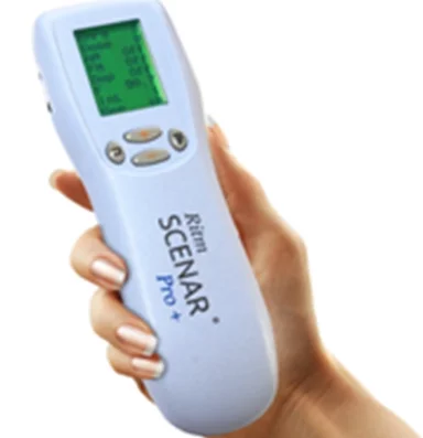 Hand holding a RITM SCENAR Pro device with a green display and control buttons.