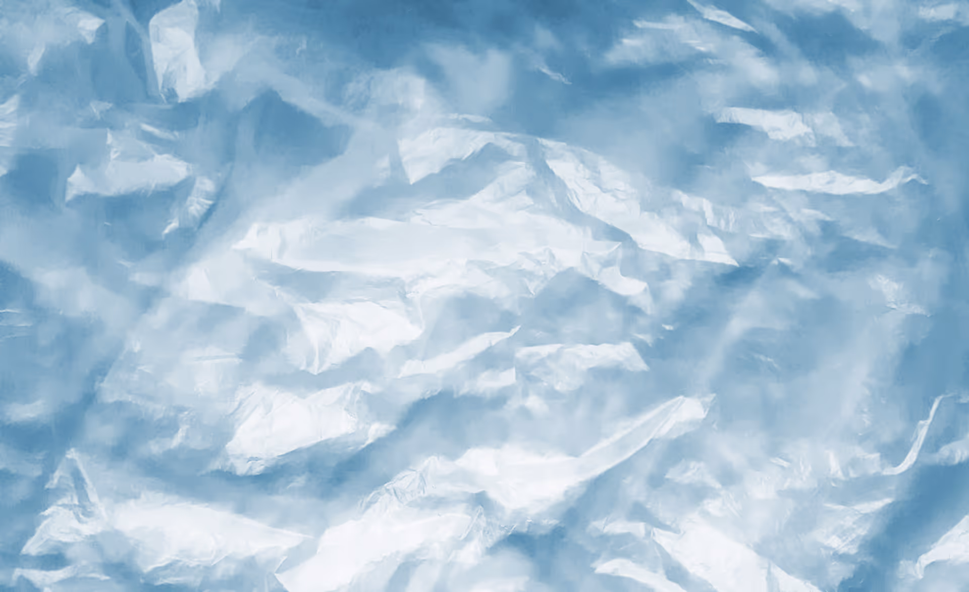 Close-up of crumpled translucent blue plastic film with wrinkles and folds.