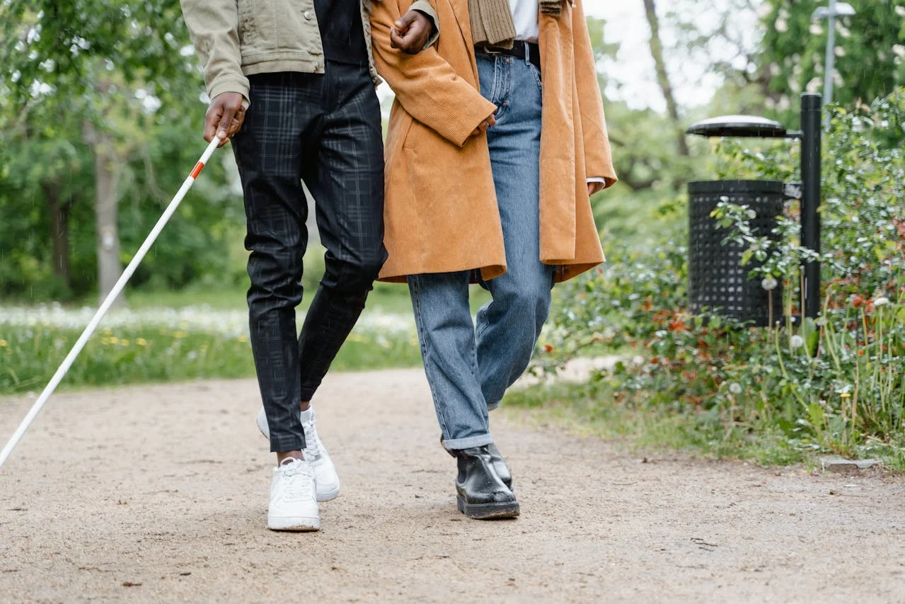 A SadieGrace participant walking with a support worker outdoors