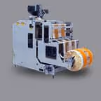 Compact industrial labeling machine with orange label rolls on a gray background.