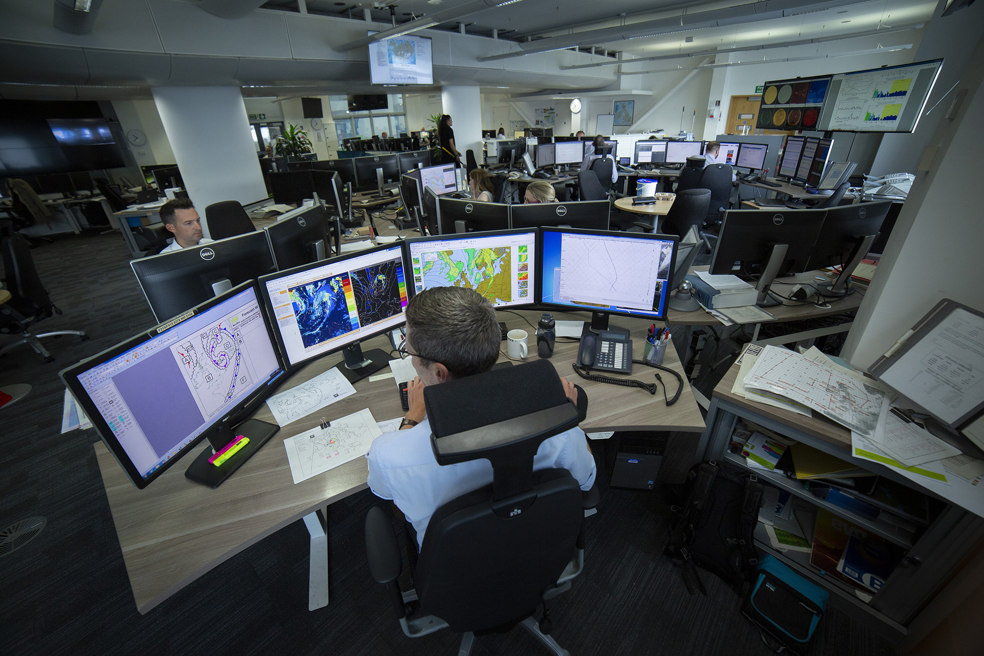 Met Office operations center with meteorologists analyzing weather data