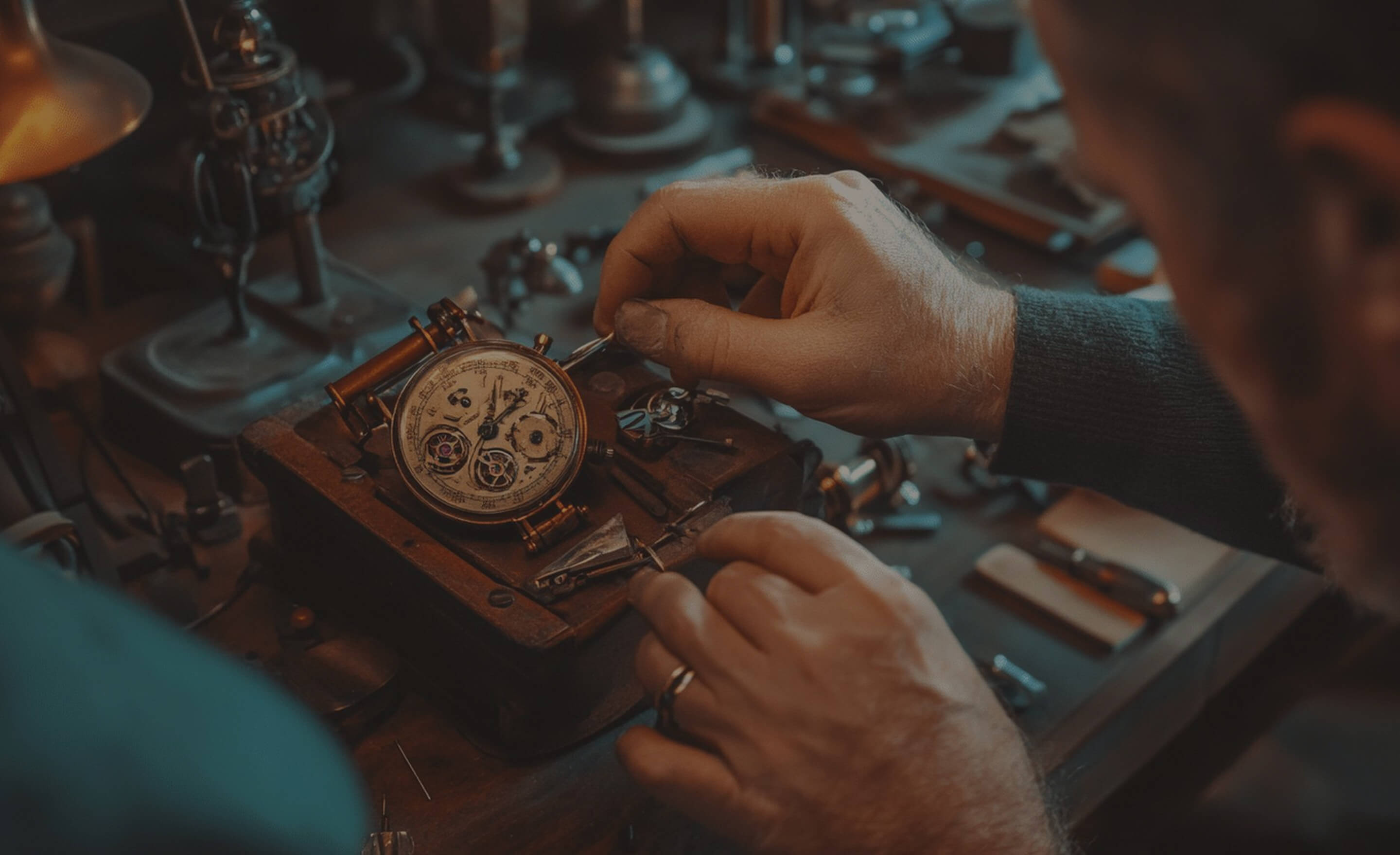 Close-up of a person repairing a vintage mechanical watch with tools on a workbench.