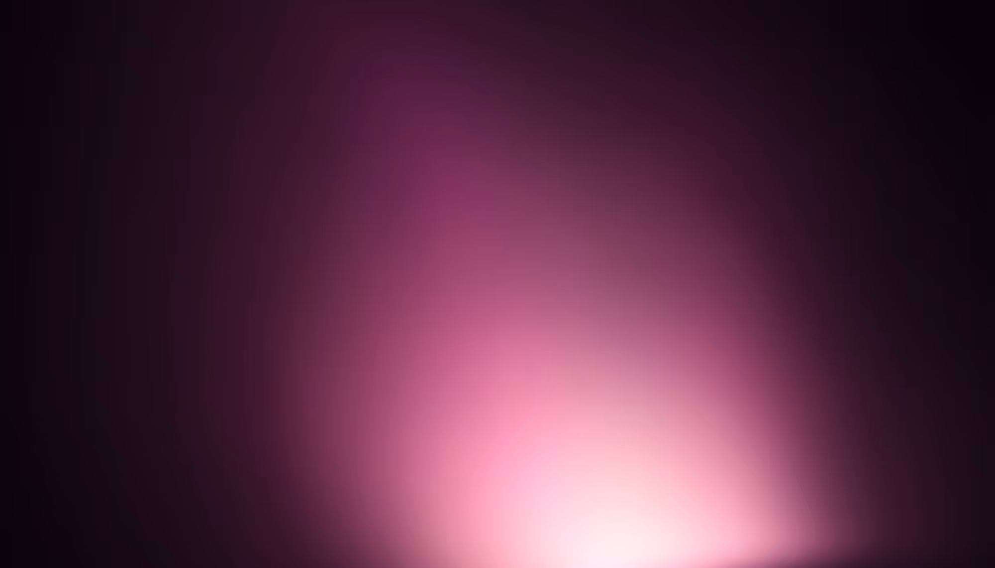 A soft, glowing pink and magenta light source emanating from the lower center of a dark, nearly black background, creating a radial gradient that fades from bright pink-white at the bottom to deep purple and black at the edges.