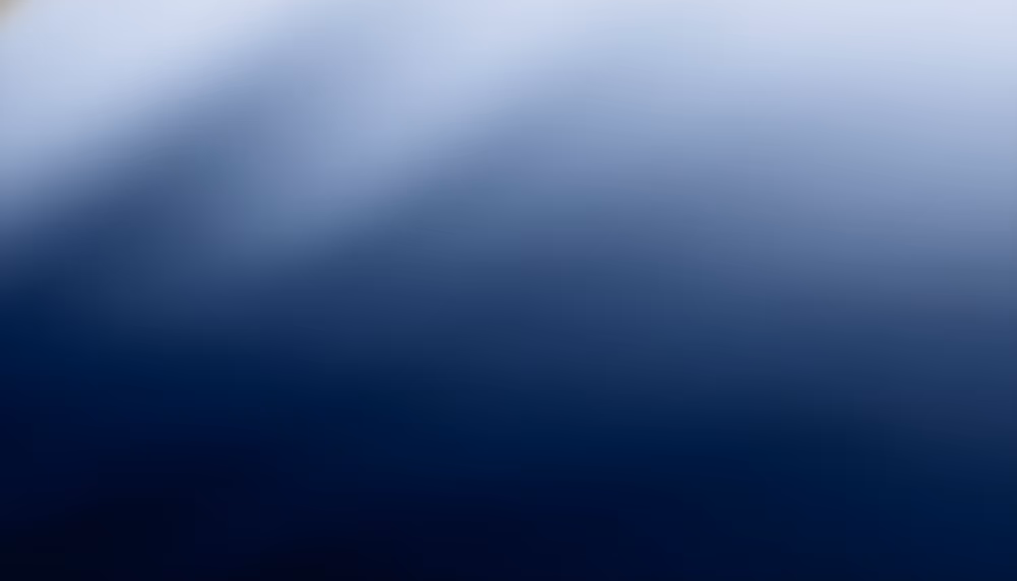 Soft blue gradient background transitioning from pale misty blue-white at the top to deep navy blue at the bottom, with subtle cloud-like tonal variations.