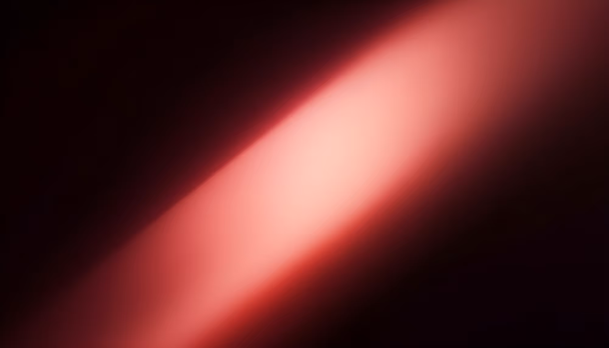 A diagonal beam of soft red and pink light cutting across a dark black background, with a bright white-pink core that fades into deep crimson at the edges.