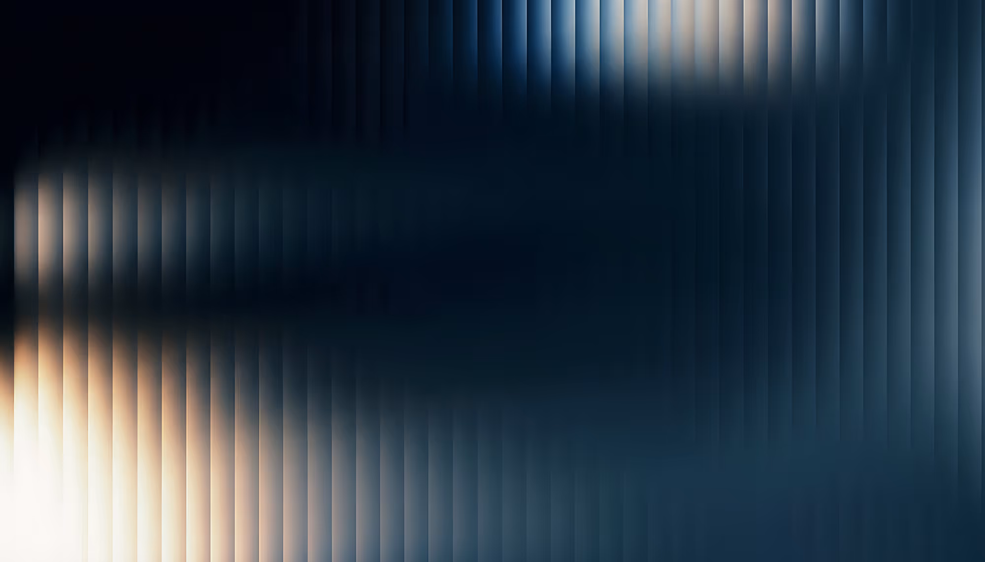 Abstract digital background featuring vertical light streaks in warm amber and white tones on the left transitioning to cool dark teal and navy blue on the right, with a soft glowing light source in the lower left corner.