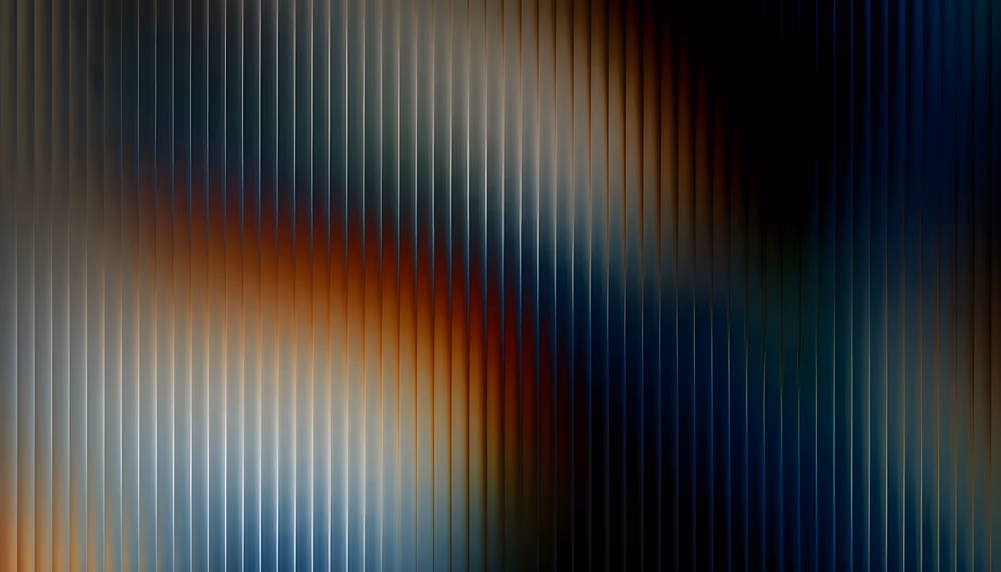 Abstract digital artwork featuring vertical ribbed lines over a gradient background that transitions from warm amber and deep red tones on the left to cool dark navy and teal on the right, creating a glowing, luminous effect.