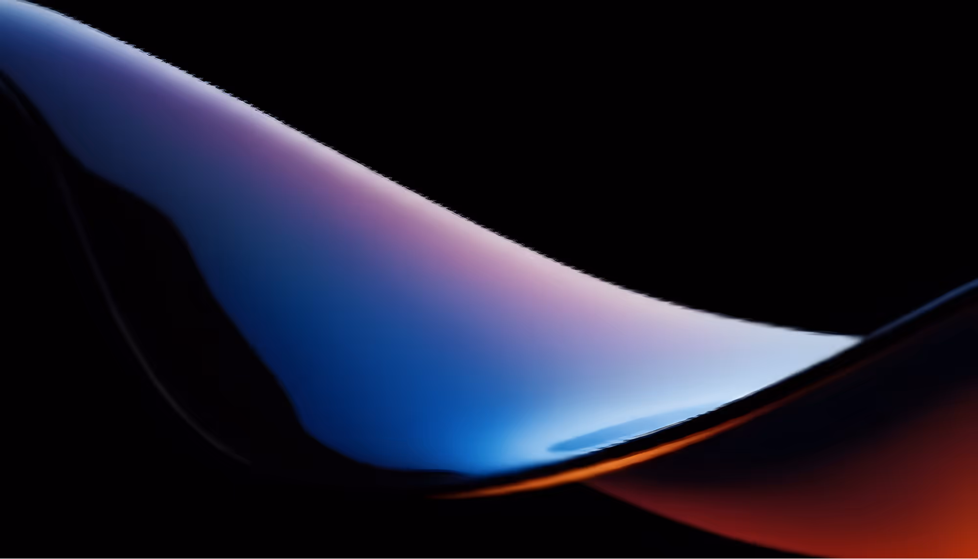 Abstract flowing wave form with a smooth gradient transitioning from deep blue and purple tones to warm orange and red, set against a black background.