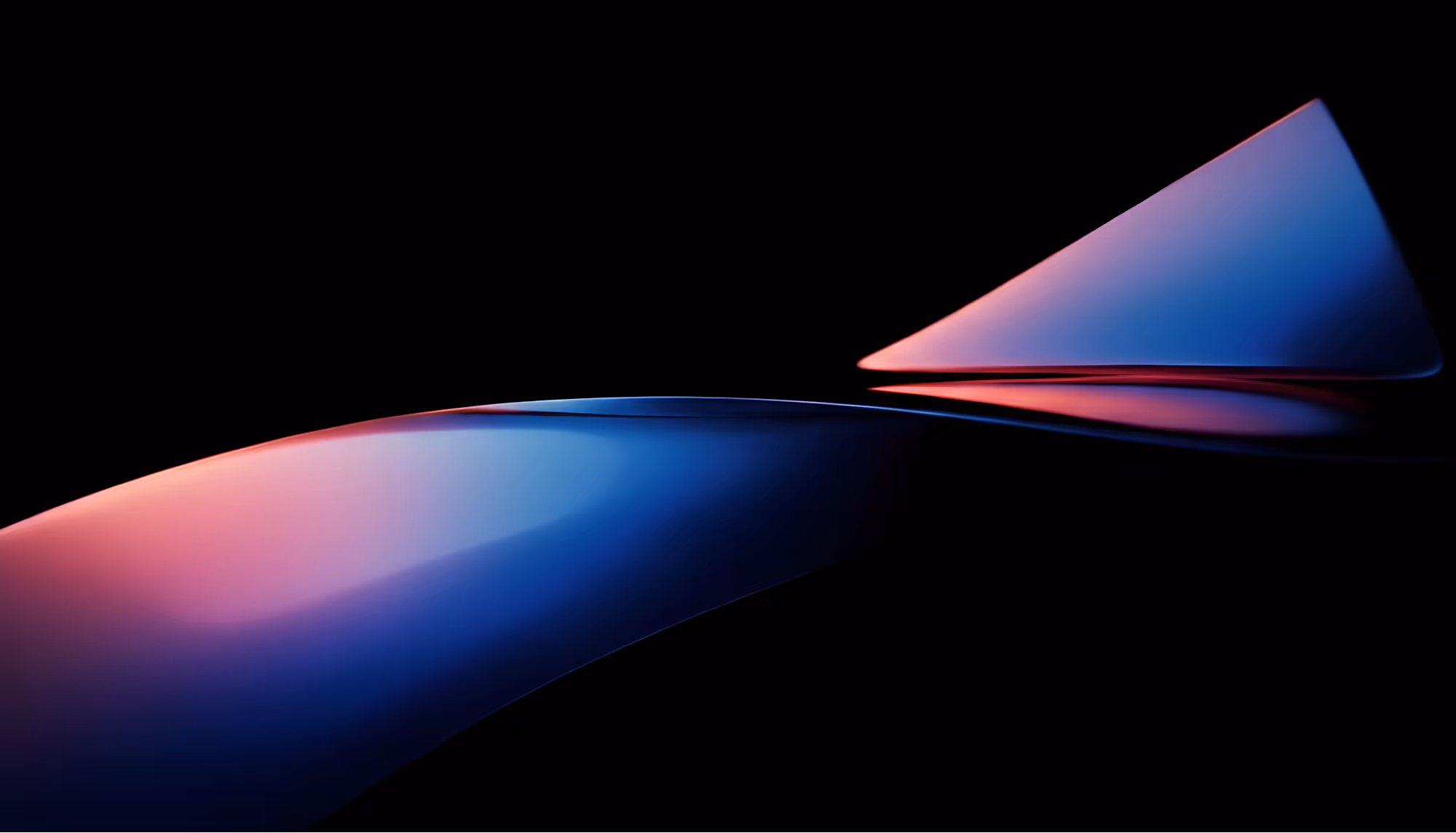 Abstract 3D render of two smooth, curved geometric forms emerging from a black background, illuminated with a gradient of deep red, pink, purple, and blue light. One form sweeps horizontally like a flowing ribbon, while a second triangular shape rises sharply in the upper right.