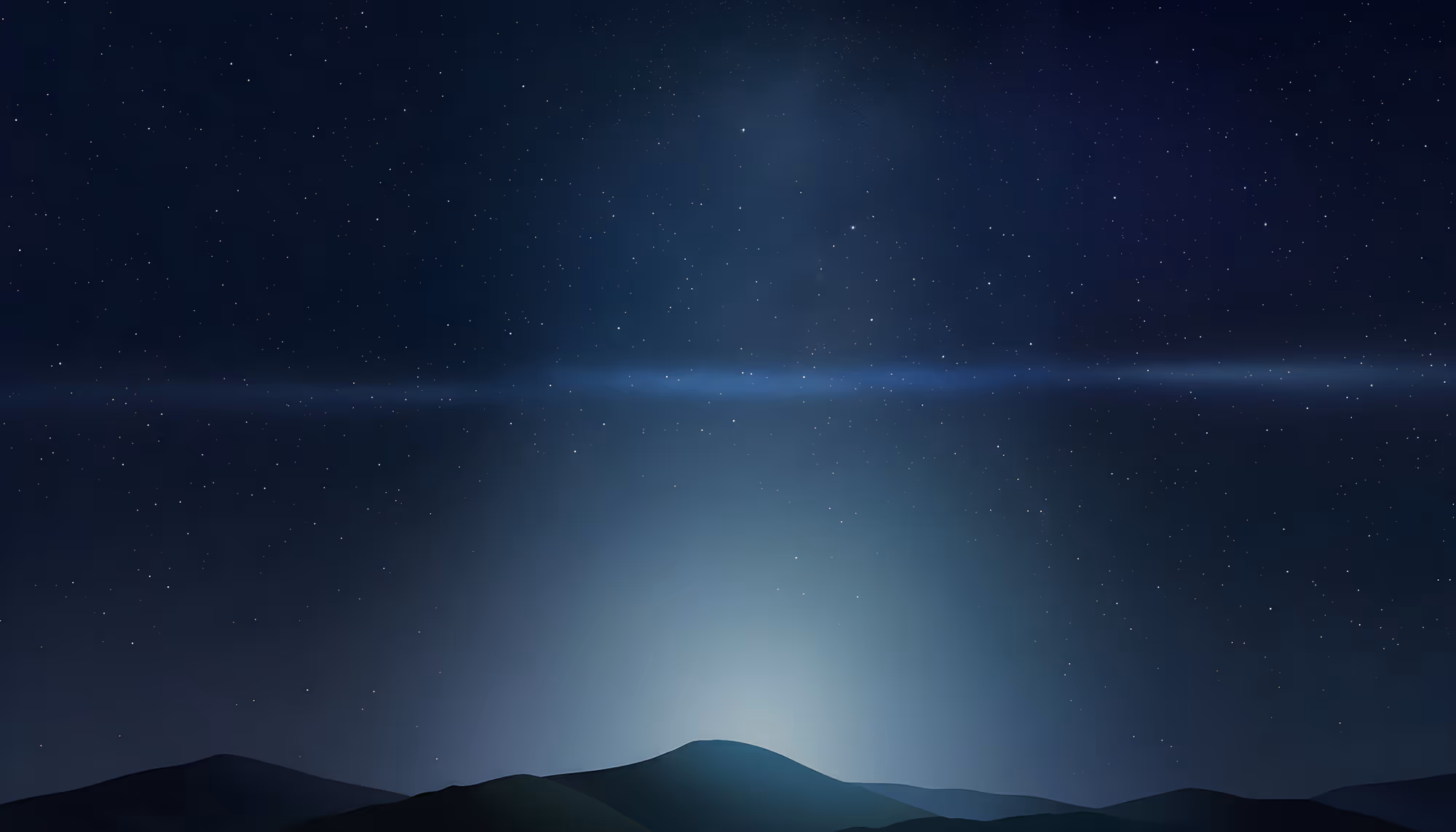 A serene night sky over silhouetted rolling hills, with a soft blue-white glow rising from behind the central peak, a horizontal band of atmospheric light crossing the horizon, and a field of scattered stars against a deep navy blue sky.