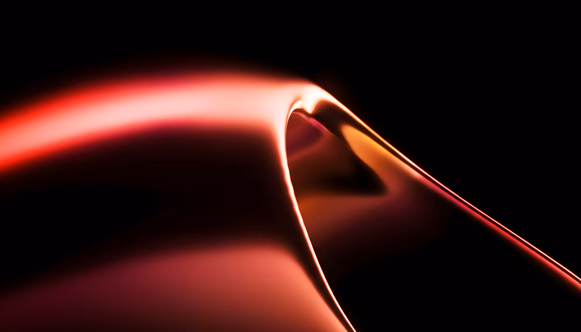 Abstract close-up of smooth, flowing curves in warm red, orange, and pink tones against a black background, resembling folded silk or a sculptural wave with dramatic lighting along its edges.