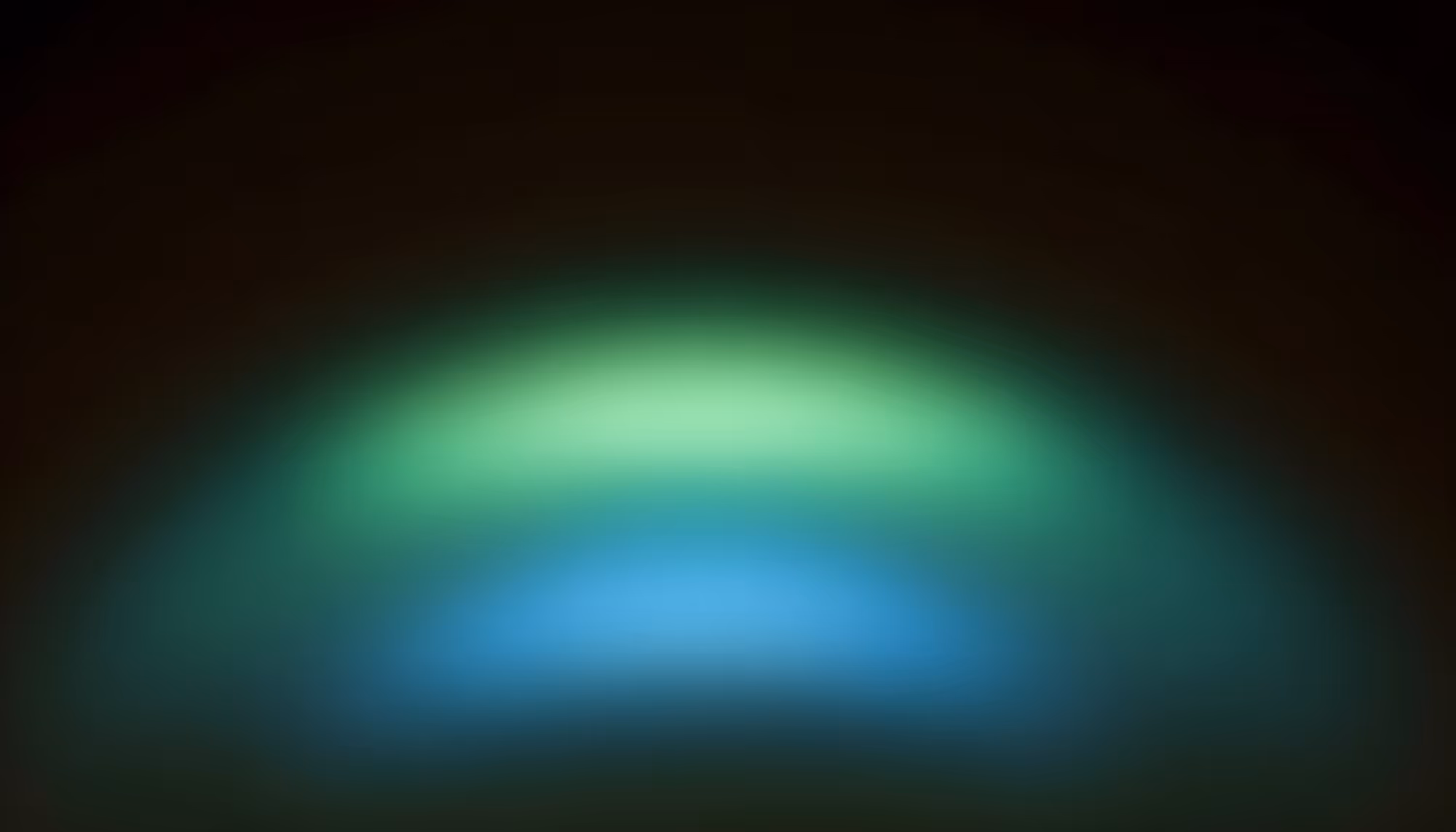 A soft, glowing aurora-like light display with an arched green band fading into teal and blue hues against a dark black background.