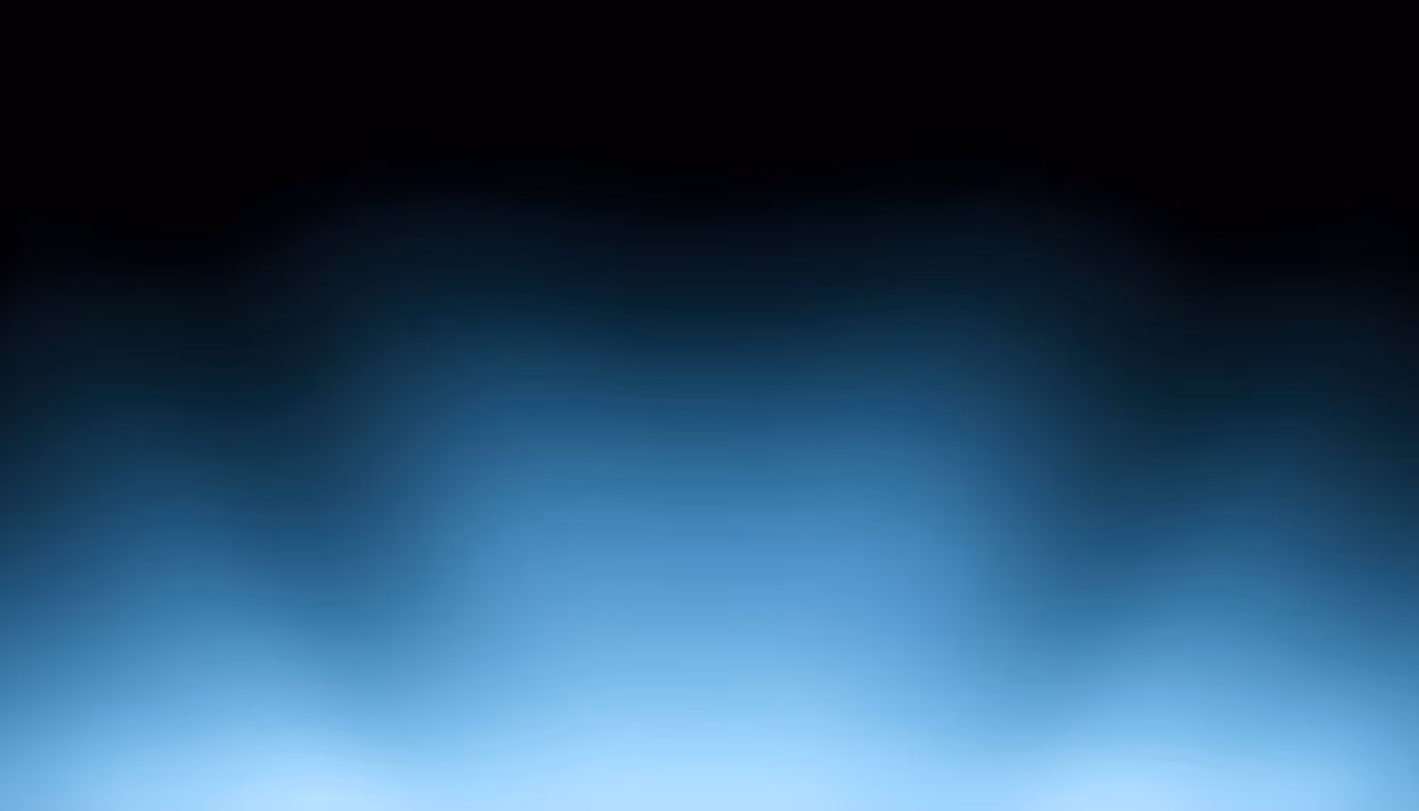 Abstract gradient image transitioning from black at the top to deep crimson and warm red tones in the middle, with a soft glow of orange-yellow and pale pink light along the bottom edge, resembling embers or a distant fire against a dark background.
