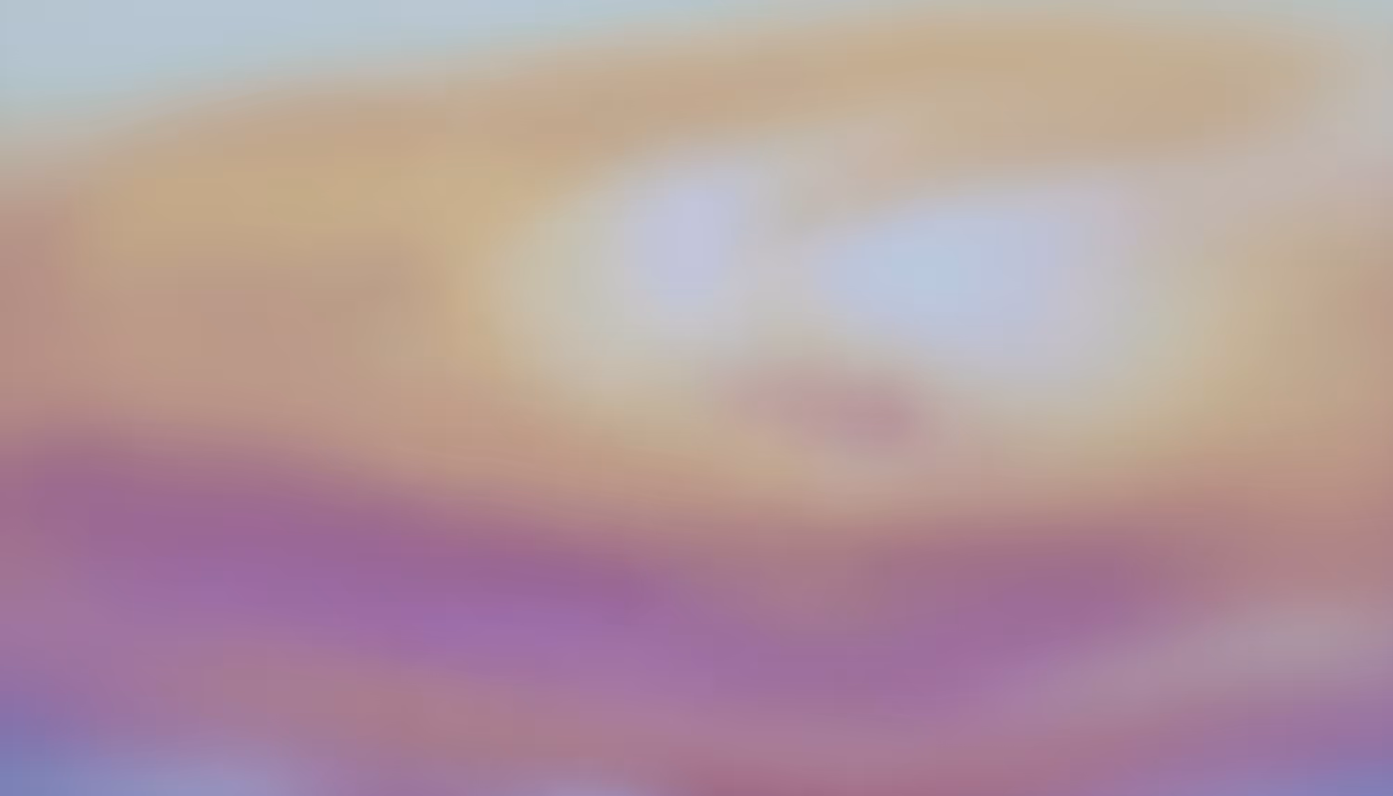 Abstract image featuring soft, blurred shades of orange, pink, and purple creating a peaceful, dreamy atmosphere. No distinct shapes are visible.