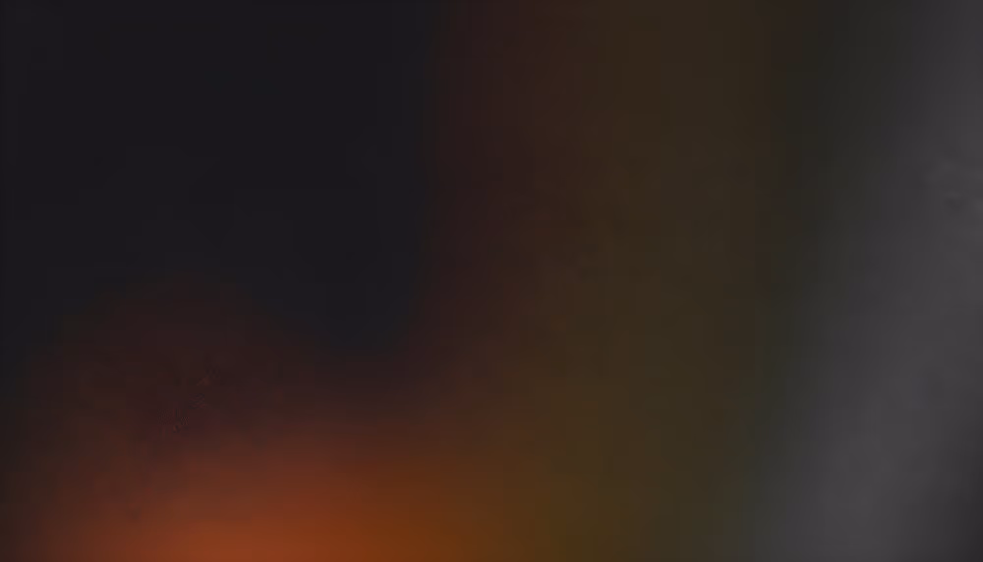 A blurred abstract gradient of dark and warm tones blends seamlessly, creating a moody atmosphere. Hints of orange and red fade into black and gray.