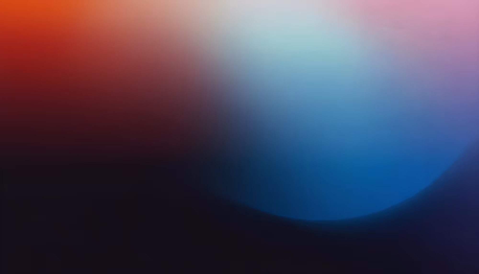 Abstract image with a gradient blending red, orange, pink, and blue hues. The colors fade into each other, creating a soft, calming atmosphere.