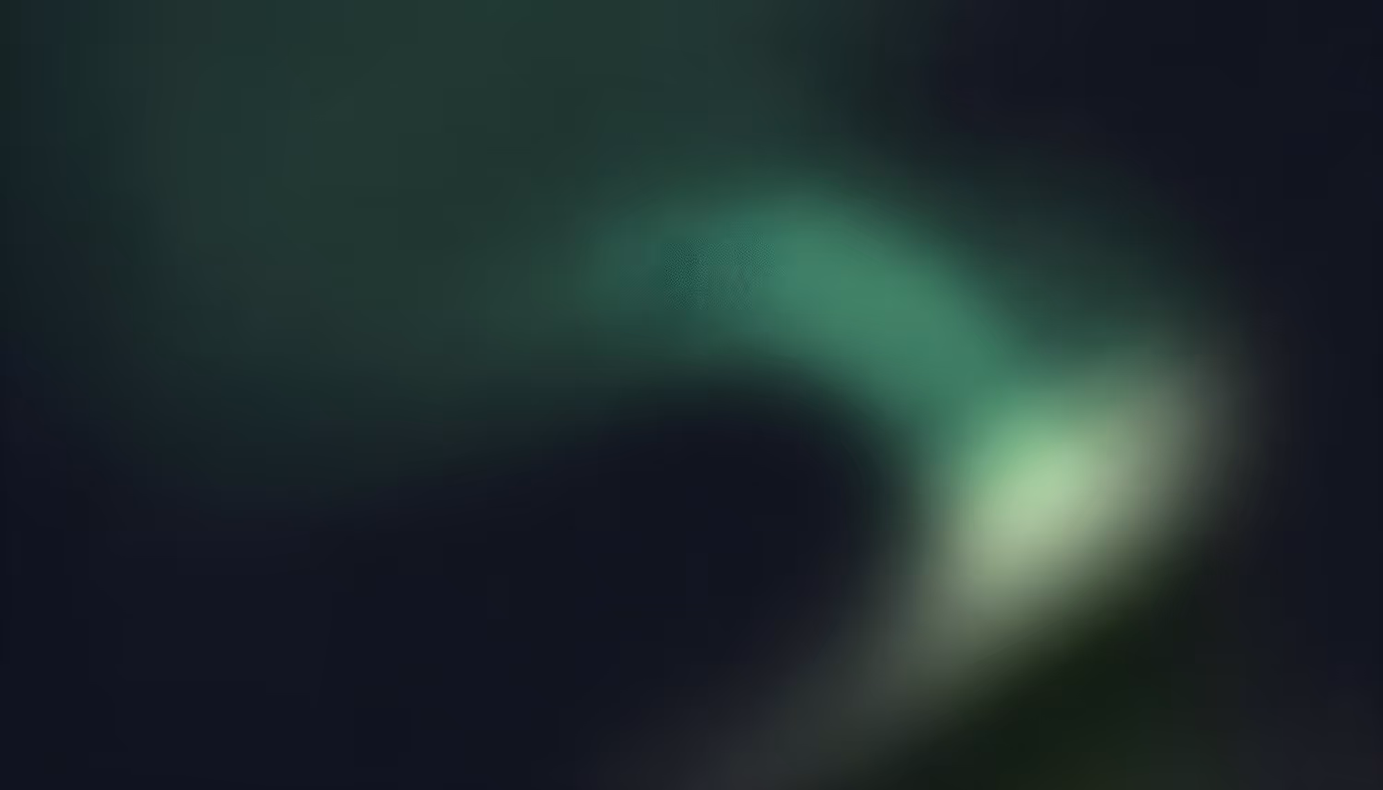 A blurred abstract image featuring a gradient of dark blue and green hues, suggesting movement with soft, flowing light. The tone is calm and mysterious.