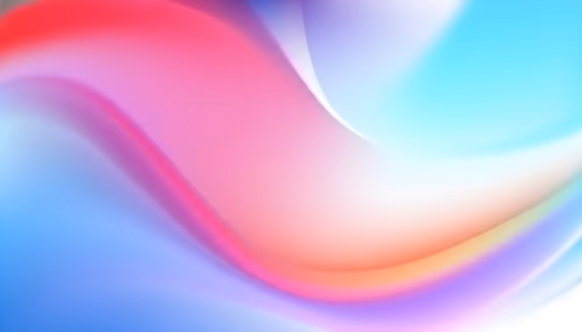 Abstract image with blended colors forming a smooth wave pattern. Pink, red, blue, and purple hues create a serene, fluid gradient effect.