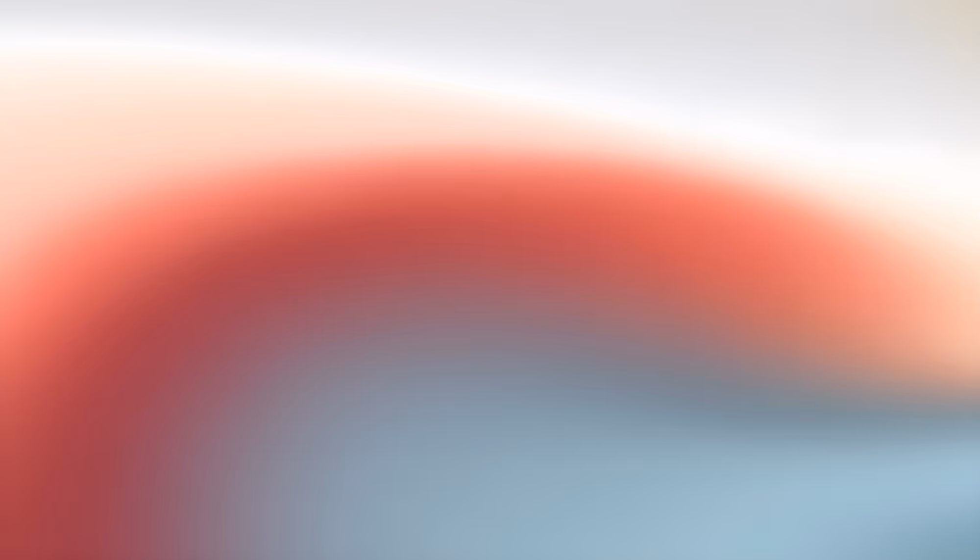 Blurred abstract image with gradient colors blending from soft white to coral red and blue, creating a calm and soothing effect.