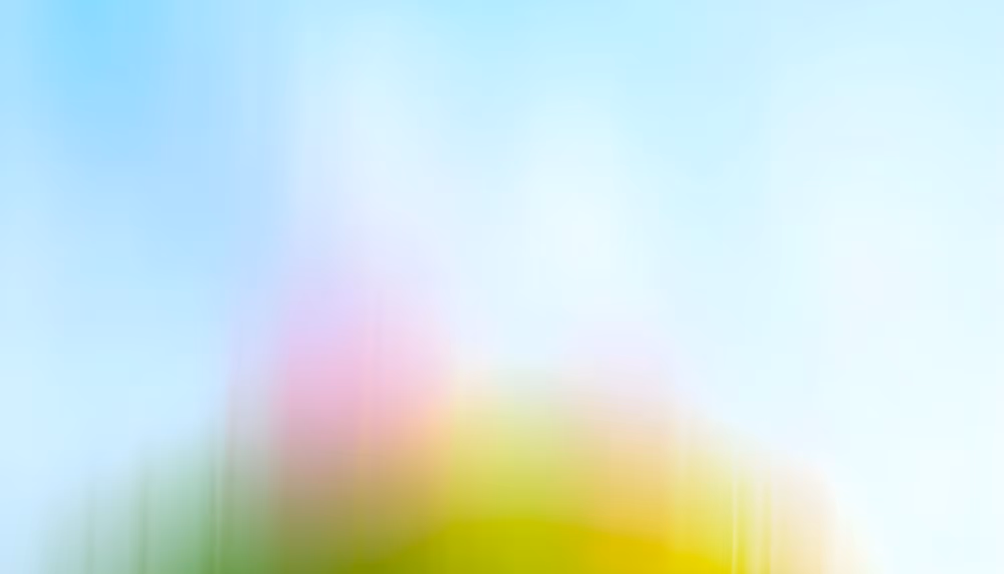 A soft, abstract blur of pastel colors with dominant light blues, greens, and pinks. The image conveys a tranquil and dreamy atmosphere.