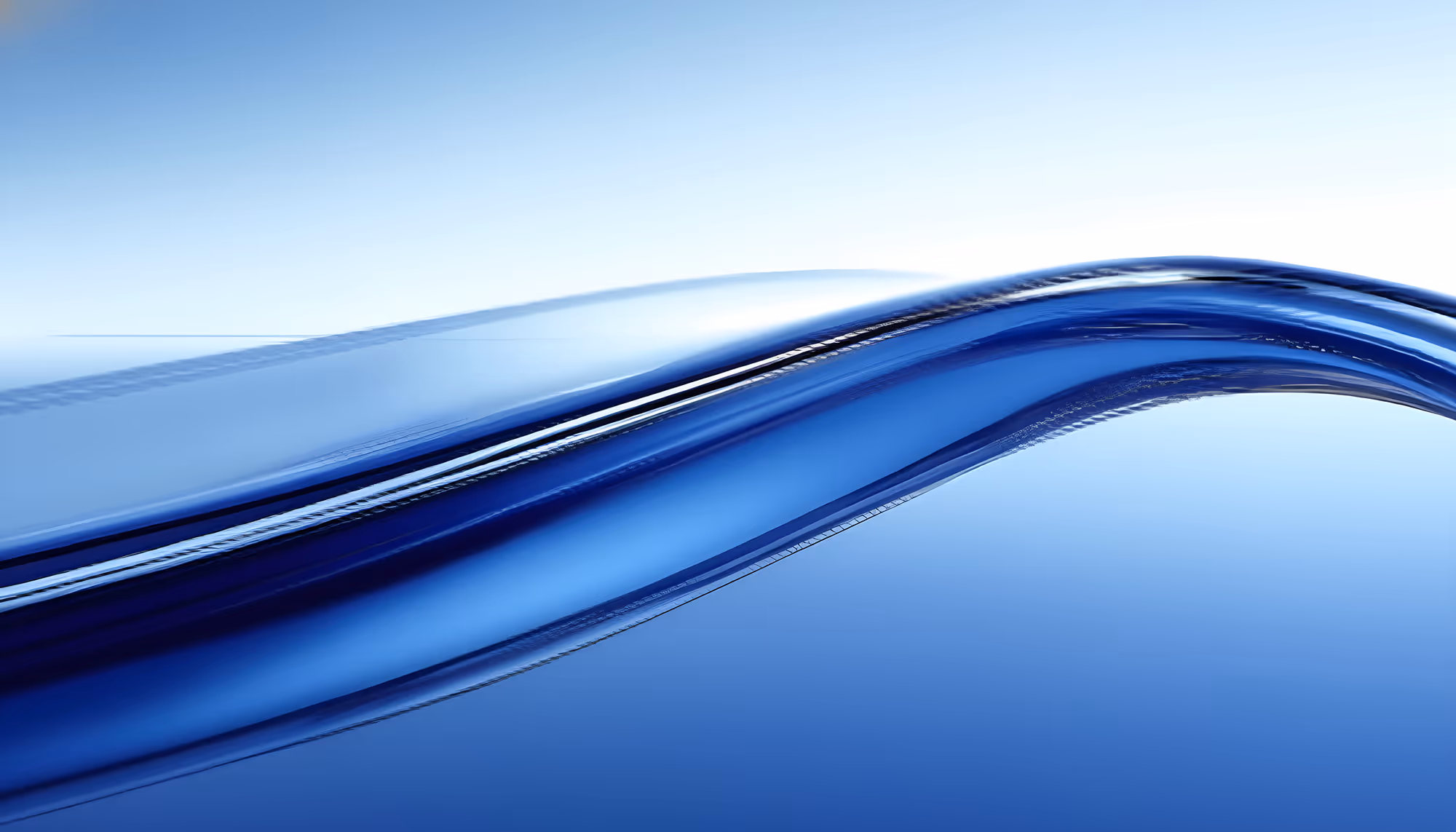 Abstract image of a smooth blue wave against a light blue background, evoking calmness and fluidity. The wave curves gracefully across the scene.