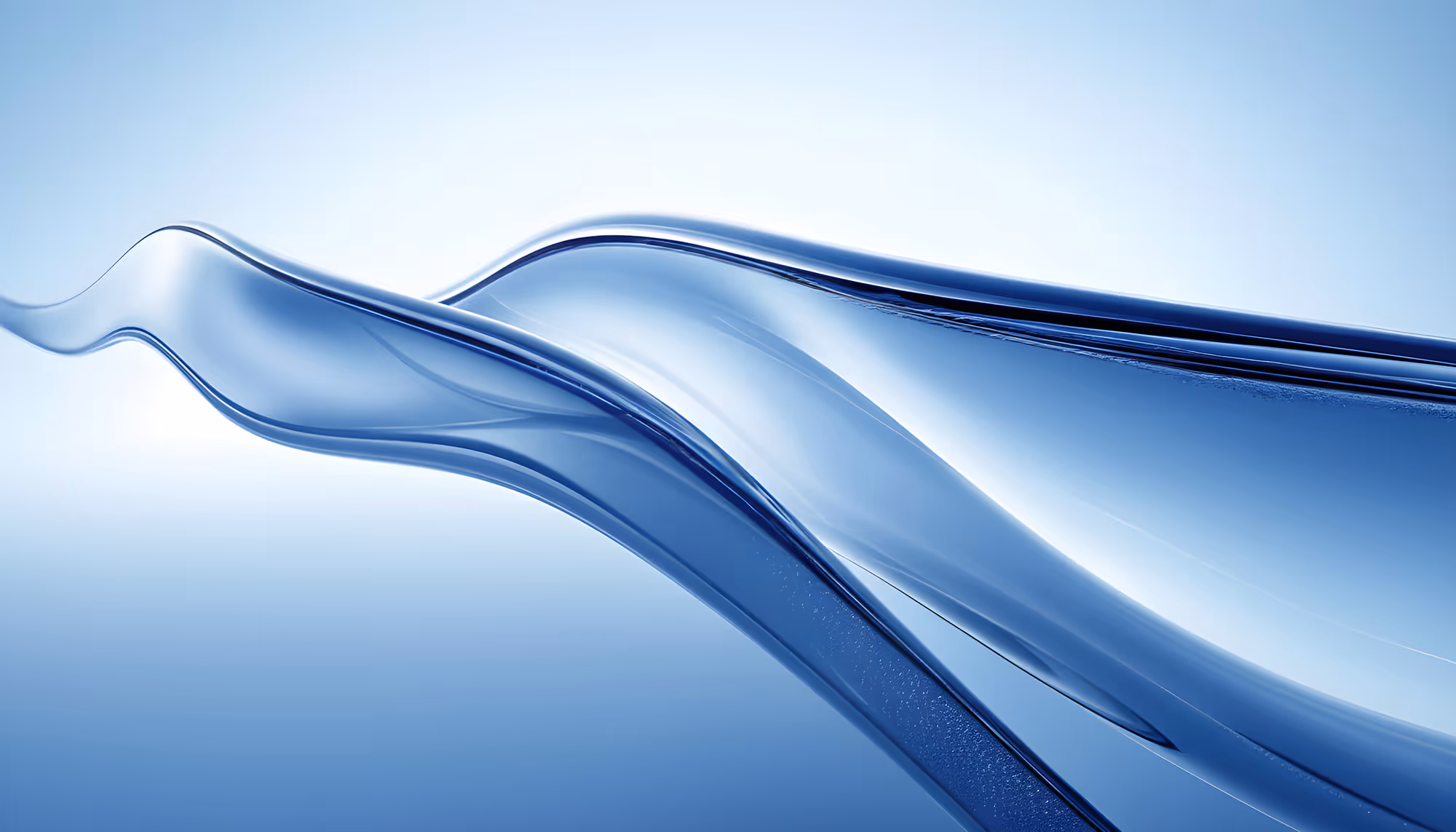 Abstract image of smooth, glass-like waves in shades of blue on a light background, evoking a sense of fluidity and tranquility.