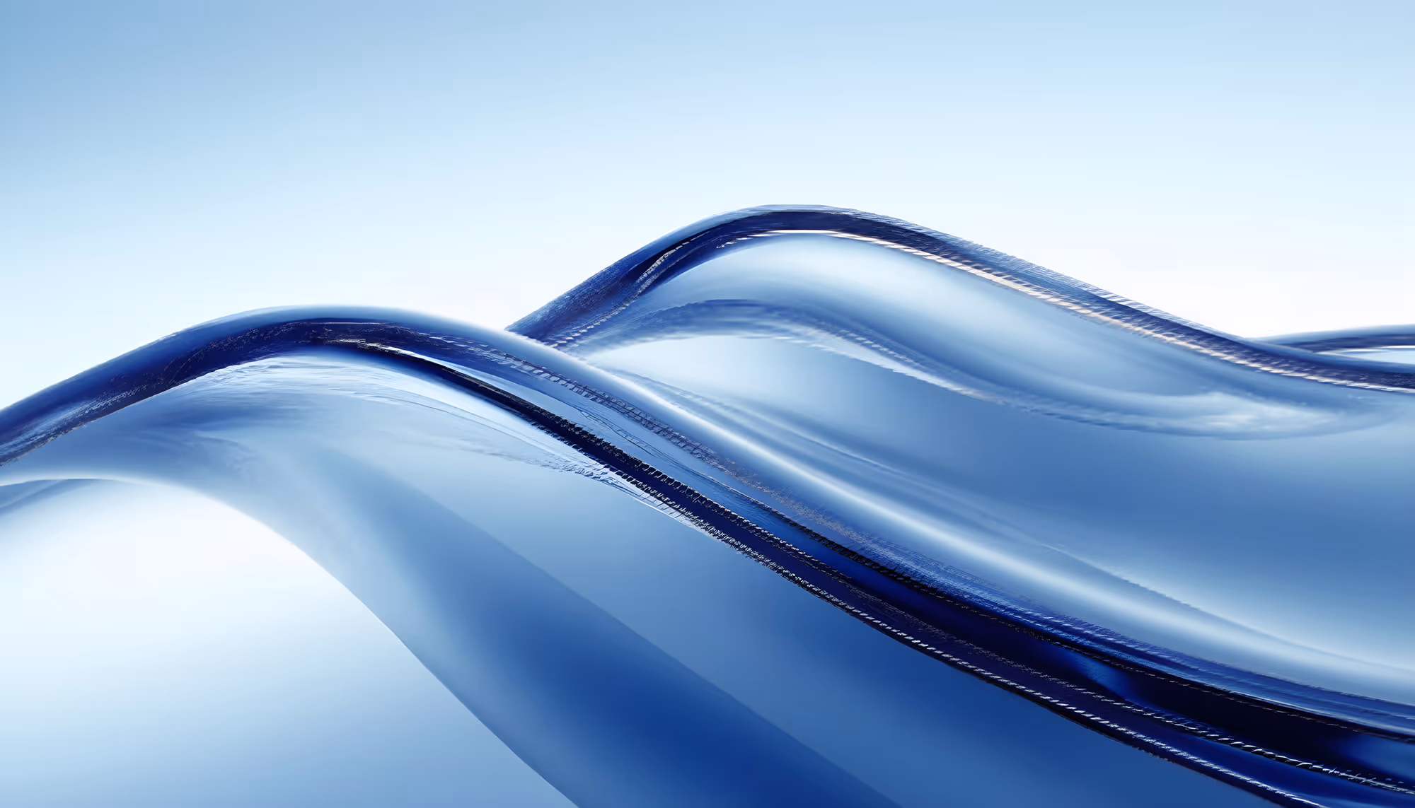 Abstract image of smooth, blue waves rising and falling against a light blue background, conveying a sense of calm and fluidity.