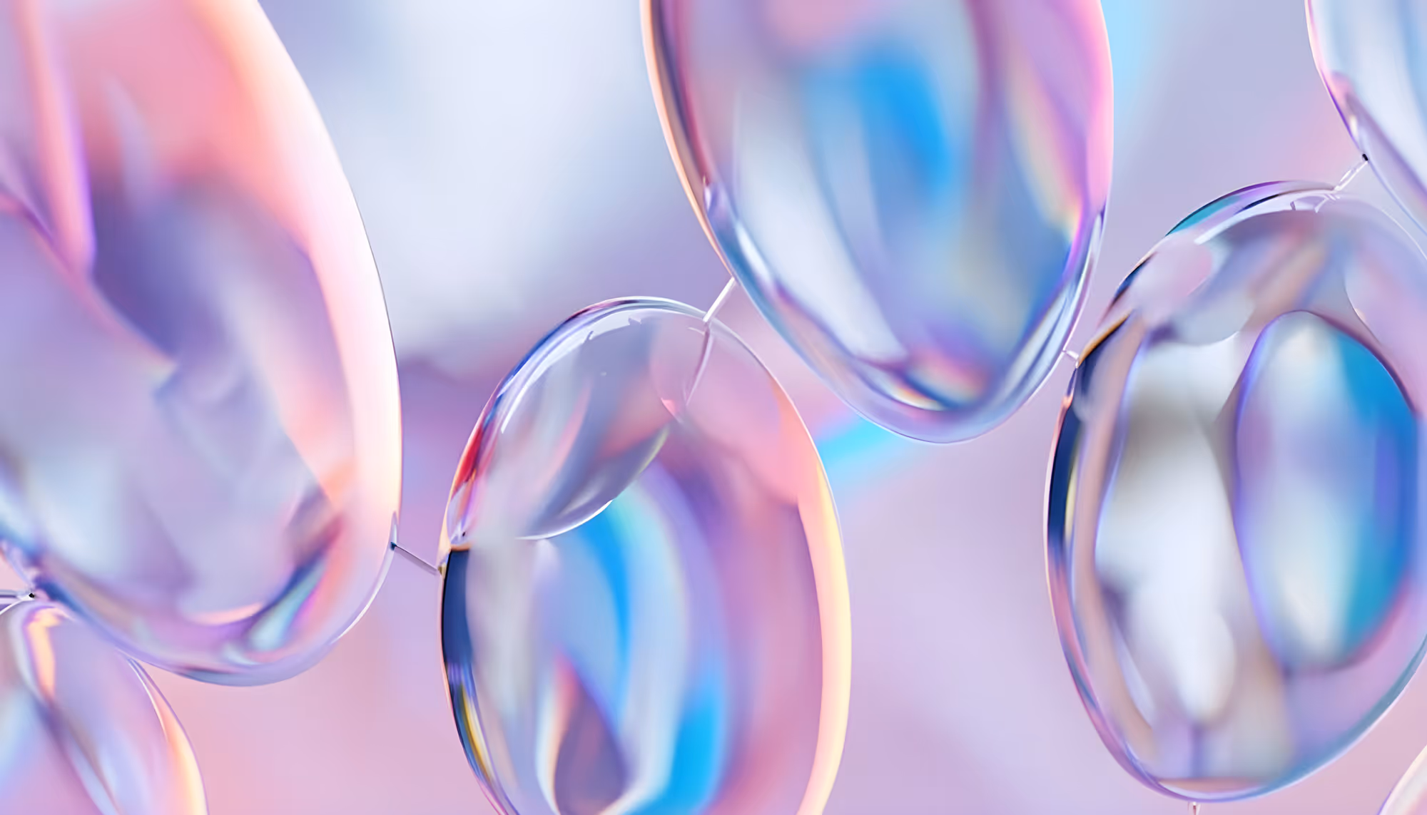 Abstract image of iridescent bubbles reflecting pastel colors like pink, blue, and purple against a soft, blurred background. Dreamy and ethereal tone.