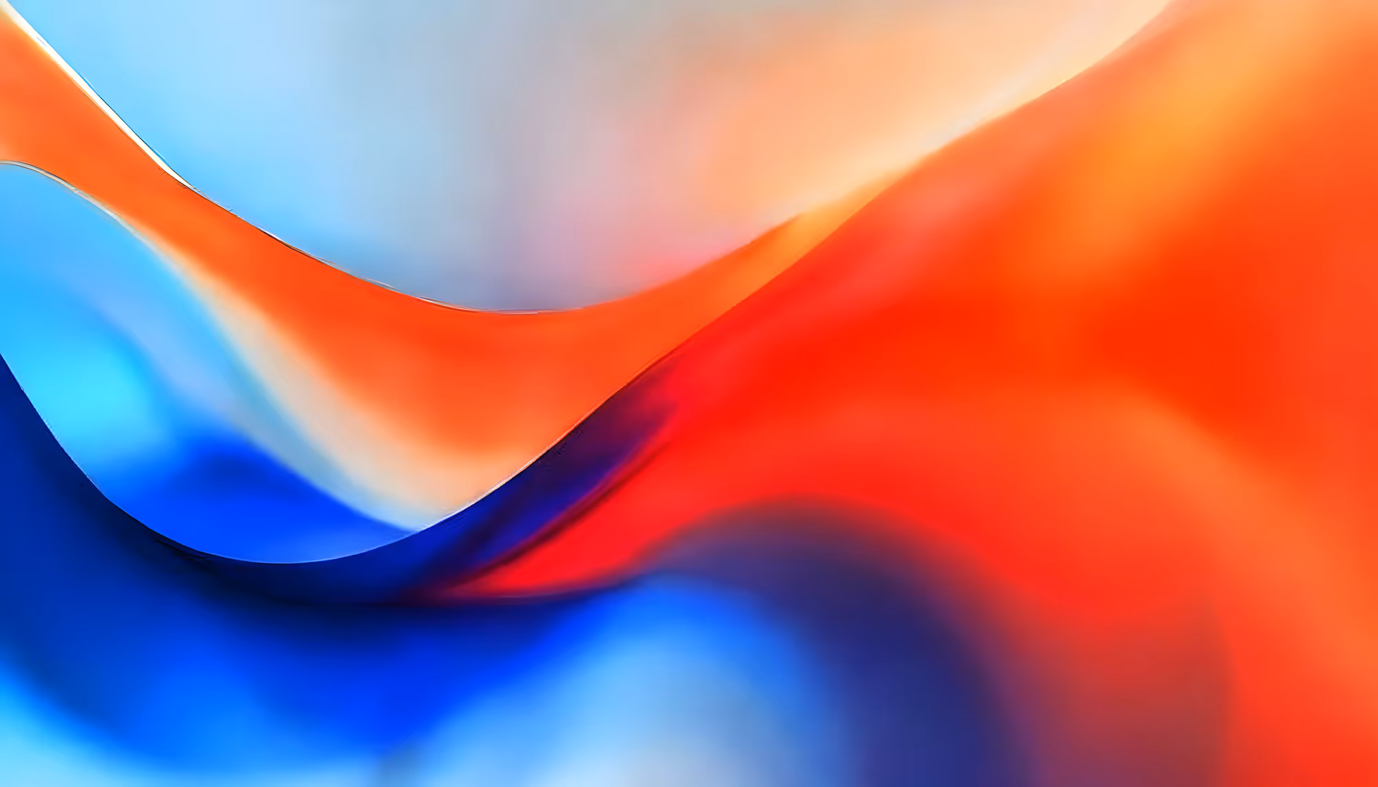 Abstract image with flowing curves in vibrant red, blue, and orange hues, blending softly into each other. The colors create a dynamic, energetic feel.