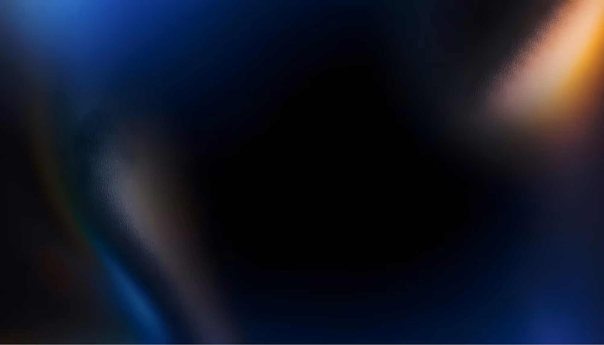 Abstract image with dark center framed by blurred, swirling gradients of deep blue, purple, and hints of orange, evoking a mysterious, serene mood.