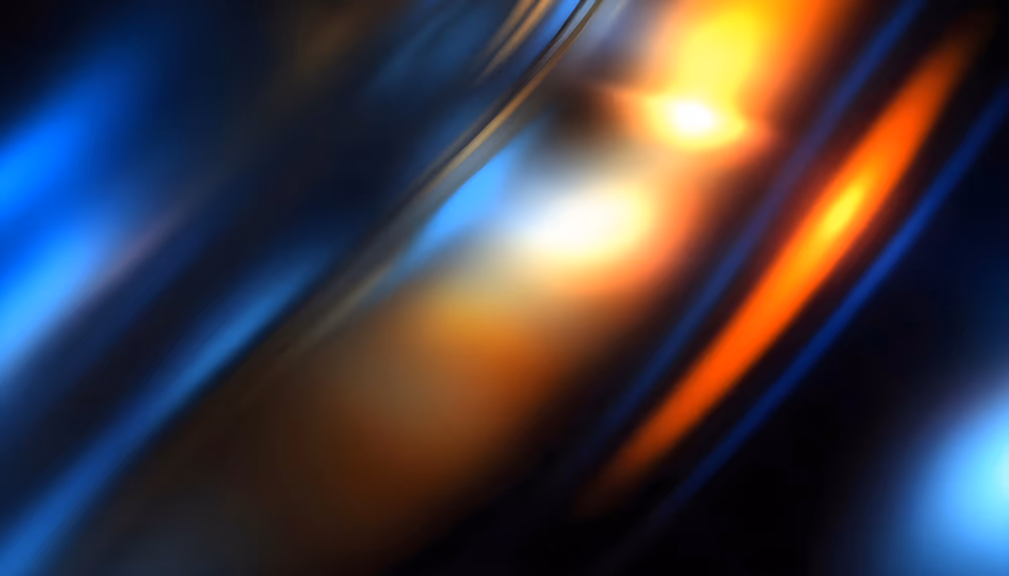 Abstract image with blurred waves of blue, orange, and yellow light. The flowing colors create a dynamic, vibrant atmosphere with a sense of motion.