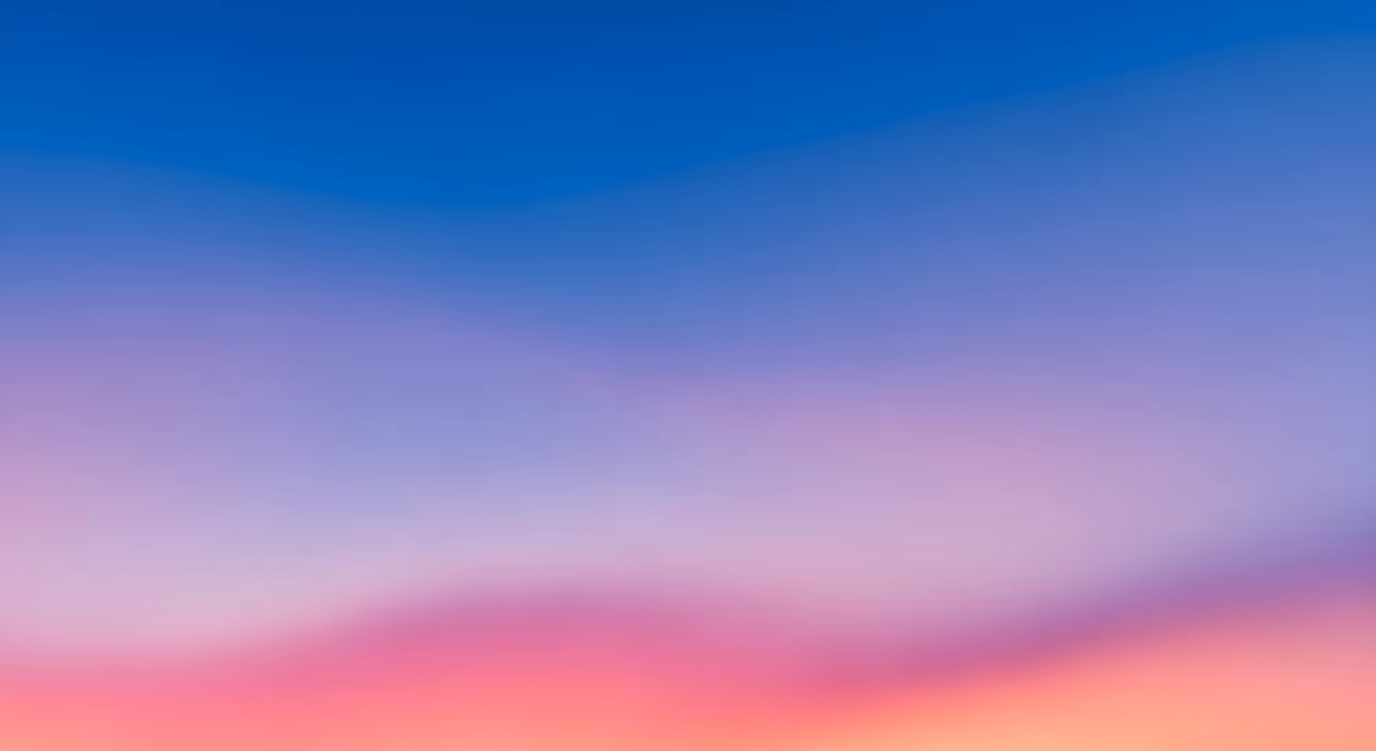 Gradient blend of blue, pink, orange, and yellow hues, creating a serene and vibrant atmosphere, reminiscent of a dreamy sunset sky.
