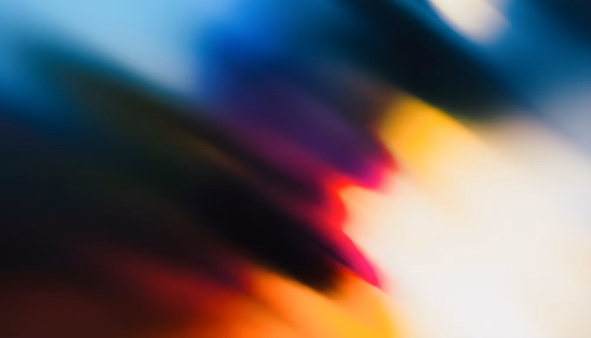 Abstract image with vibrant streaks of blue, purple, orange, and yellow blending diagonally, creating a dynamic, energetic, and colorful composition.