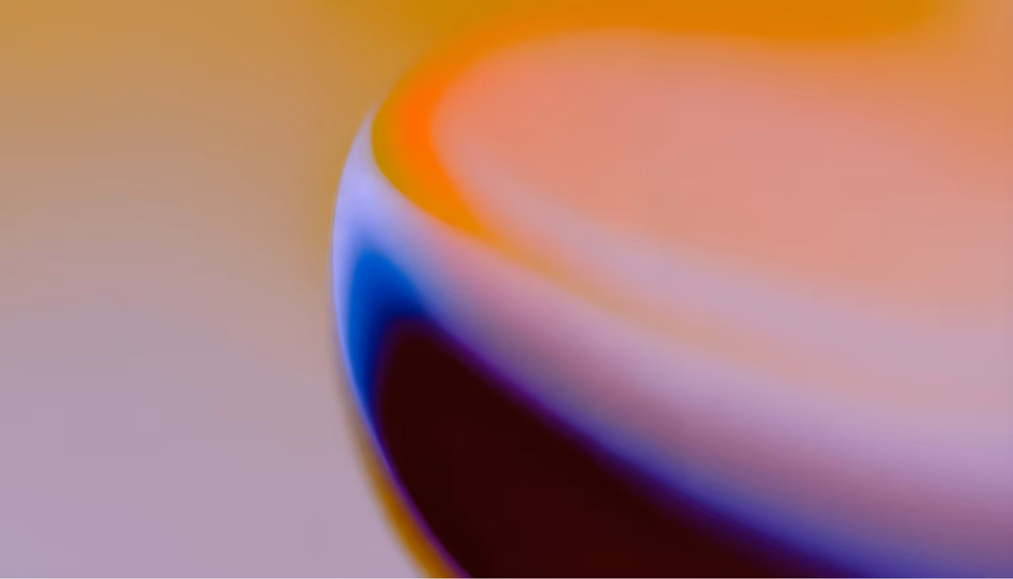 Abstract image featuring a blurred gradient with vibrant hues of orange, yellow, blue, and purple. The colors blend smoothly, creating a soft, calming effect.