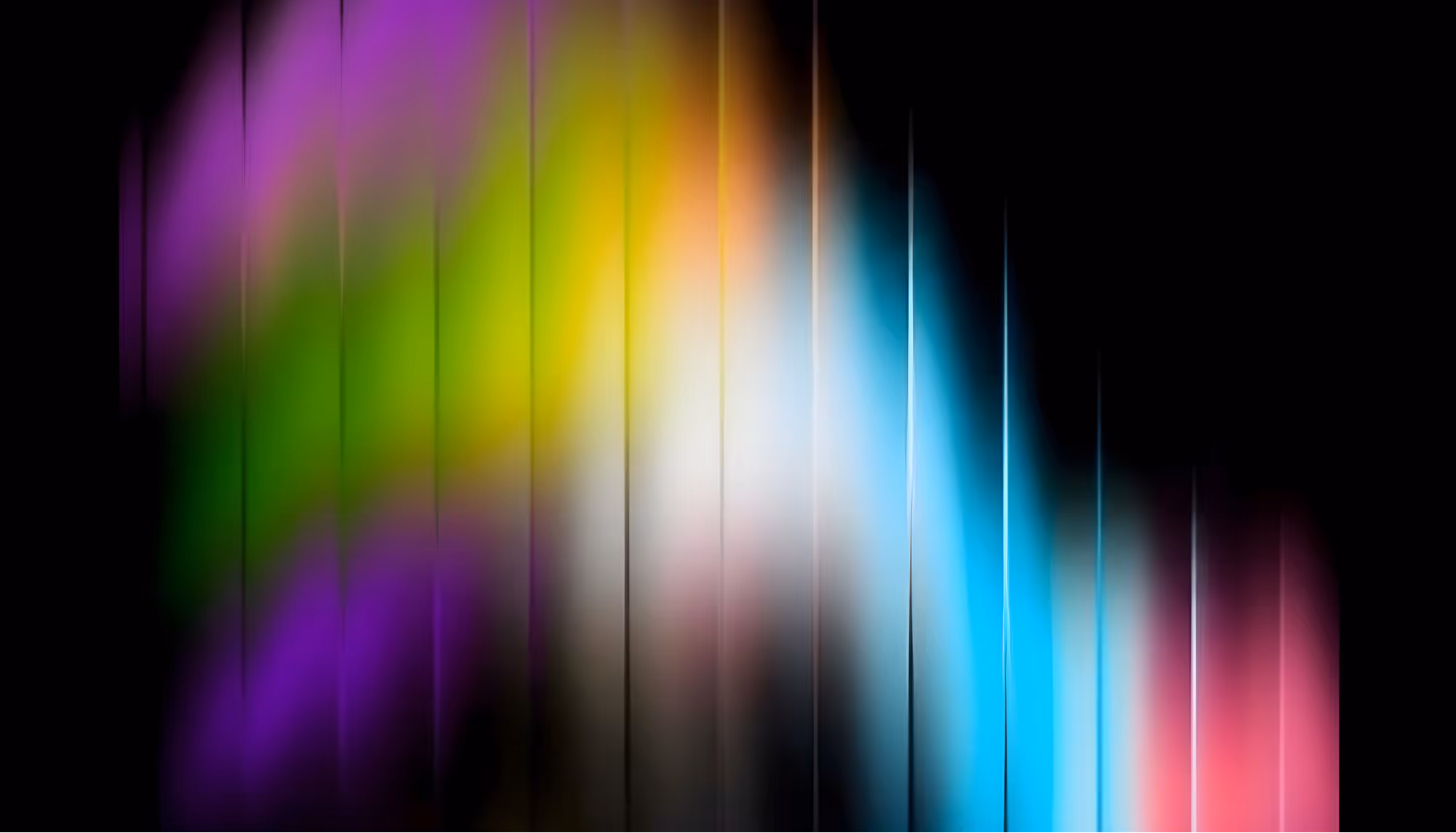 Abstract image featuring vertical, colorful streaks on a black background. Streaks blend green, purple, yellow, blue, and pink, creating a dynamic wave effect.