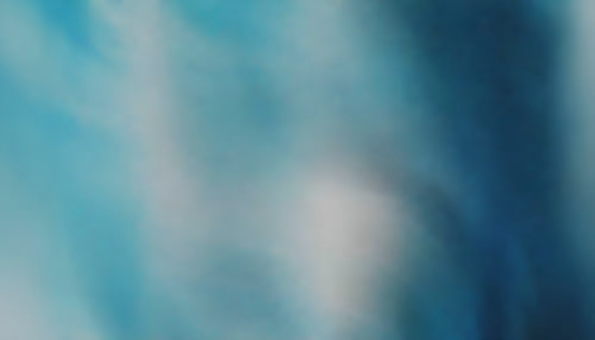 Blurred abstract image with a mix of blue and white tones, creating a calming, soothing effect. The color transitions evoke a sense of tranquility.