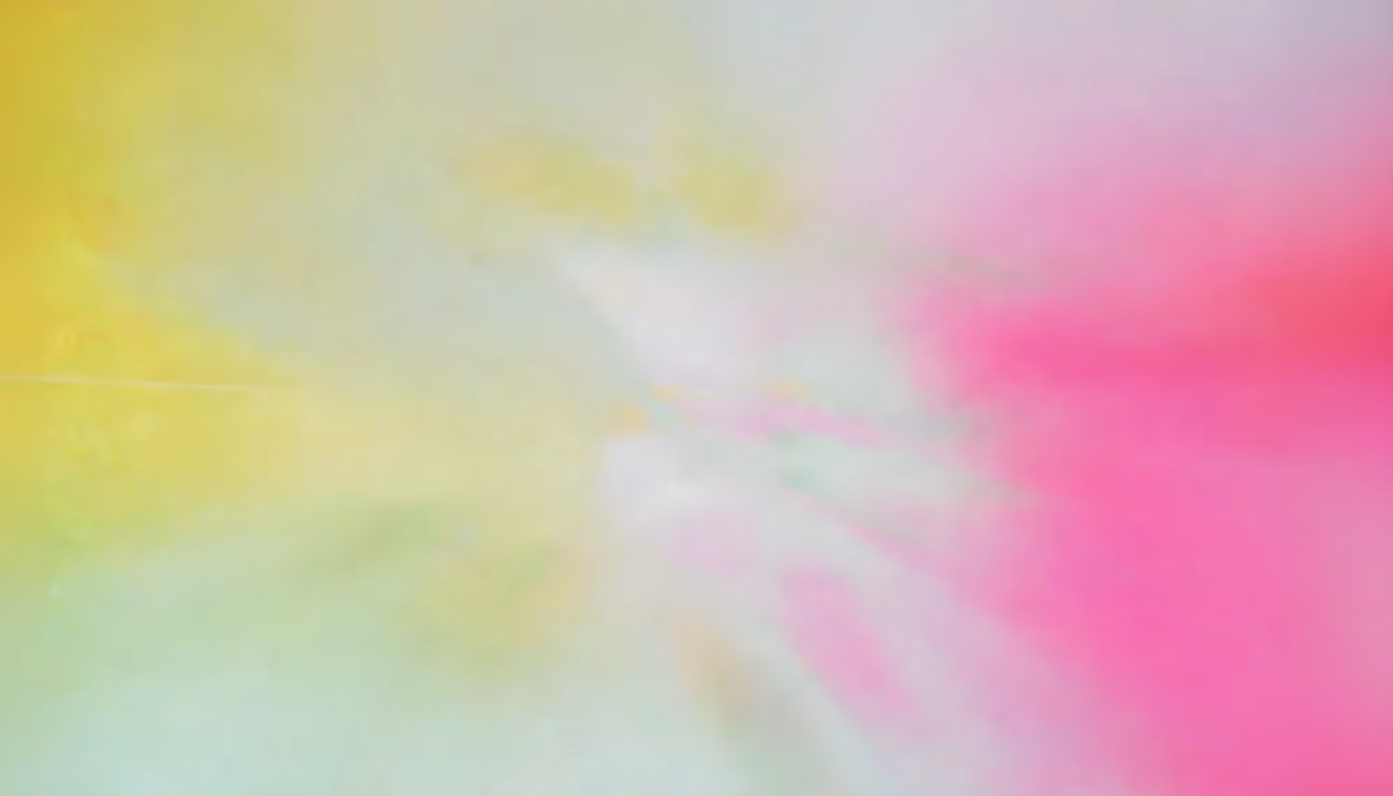Soft pastel abstract with blurred swirls of yellow, pink, and green. The light blend creates a calm, ethereal, and dreamy atmosphere.
