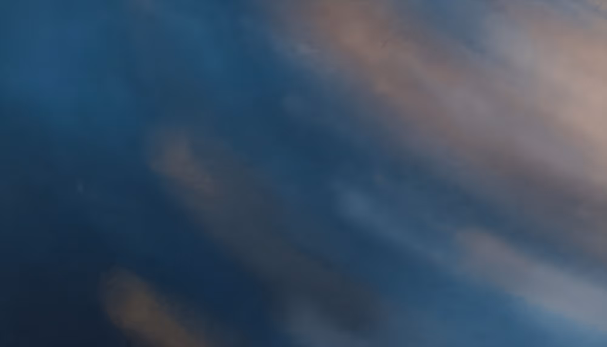 Abstract image with blurred, dreamy swirls of blue, brown, and gray, creating a soothing, ethereal mood reminiscent of a serene twilight sky.