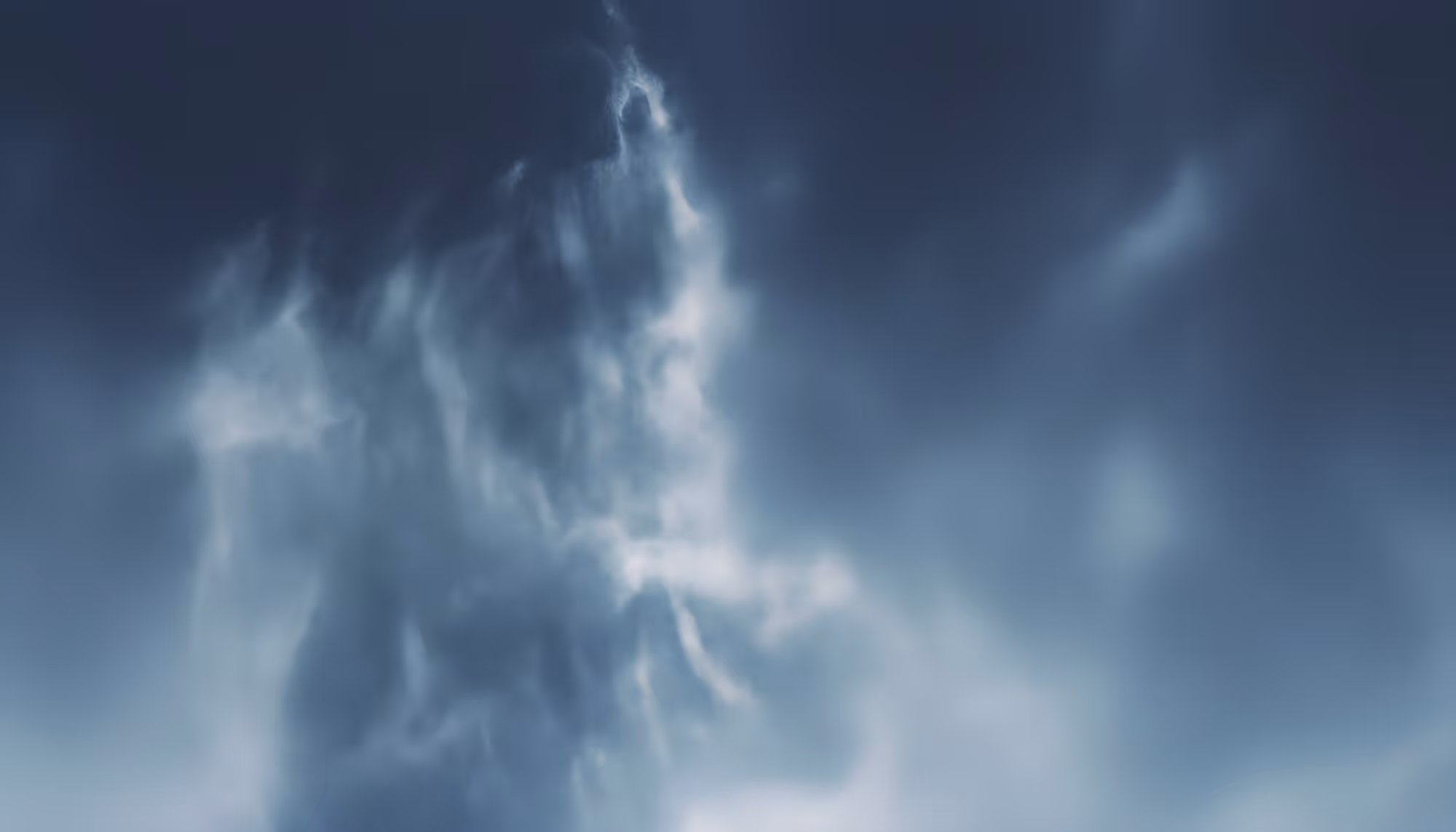 Dark, stormy sky with swirling clouds forming a dramatic, ethereal pattern. The image conveys a moody, mysterious atmosphere.