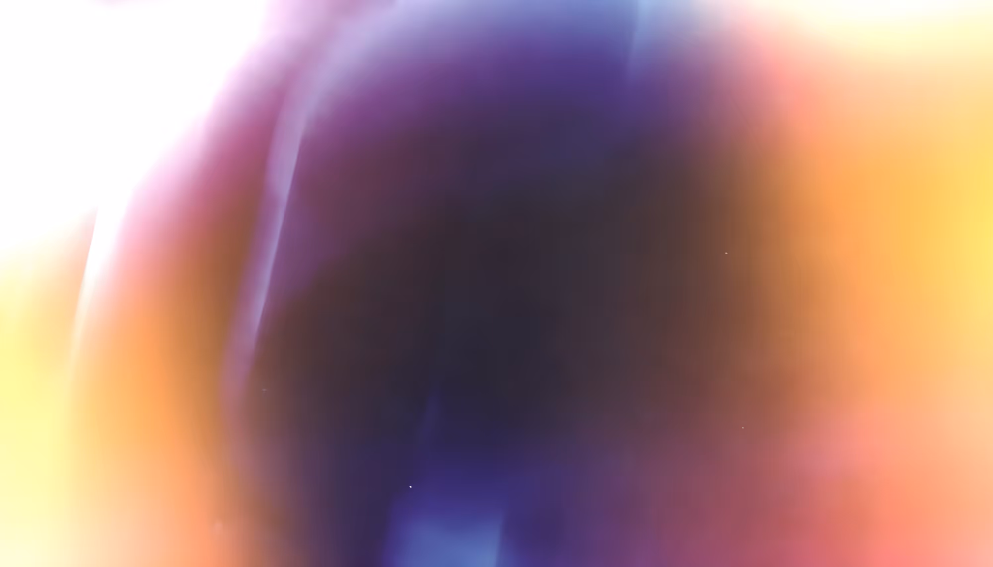 Abstract image with a blend of colors fading into each other, including deep blue, purple, orange, and bright white, creating a dreamy and ethereal effect.