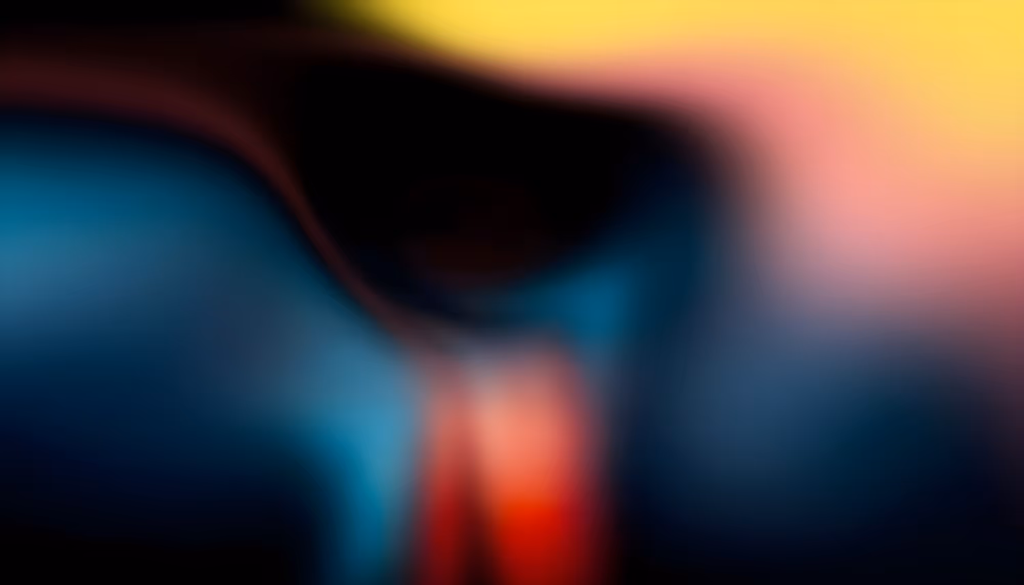 Abstract image featuring a blend of vibrant colors: deep blue, red, and yellow. Soft, flowing gradients create a sense of mystery and motion.