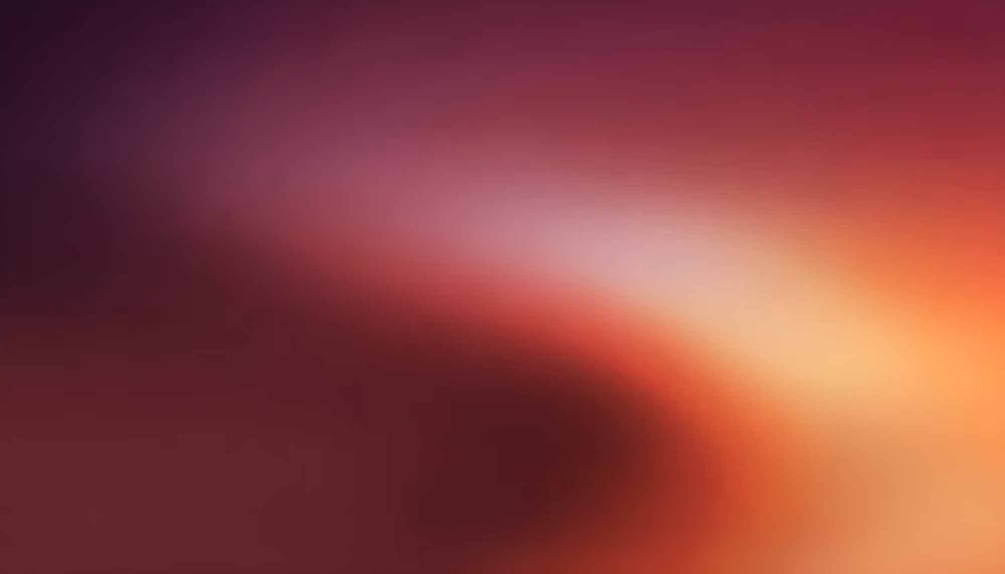 Abstract blur with rich gradients of purple, red, and orange. The soft, flowing blend creates a warm and tranquil atmosphere, with a gentle glow.