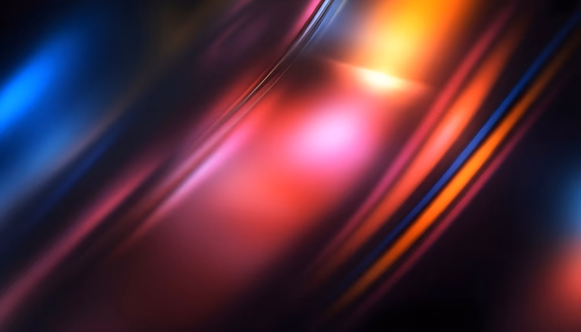 Abstract image with swirling streaks of vibrant blues, reds, and oranges, creating a dynamic, flowing pattern. The tones convey a sense of energy and movement.