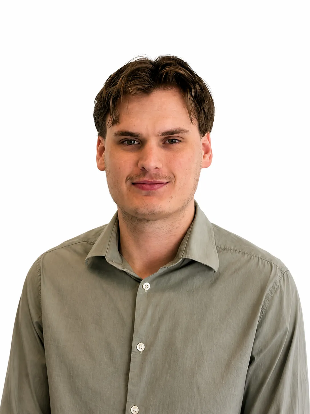 Young man with short brown hair wearing a light green button-up shirt against a white background.