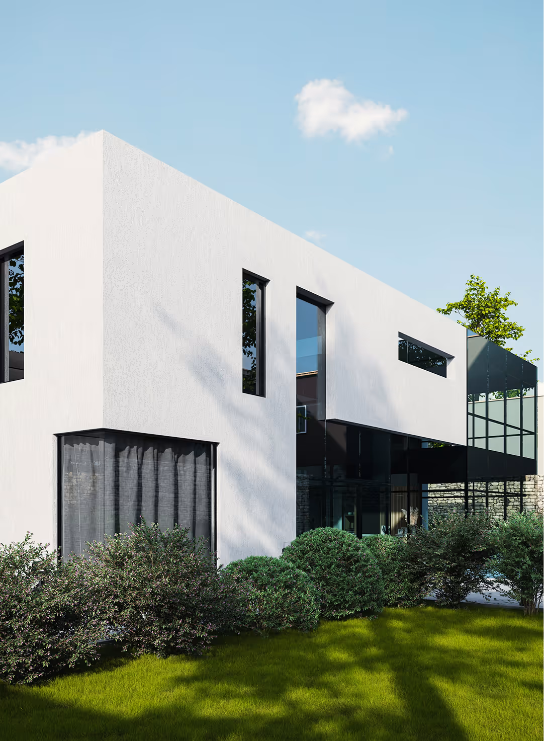 Modern white two-story house with large glass windows and green bushes in front under a clear blue sky.