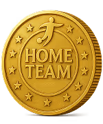 Gold coin with stars around the edge and the words 'HOME TEAM' embossed in the center beneath a stylized human figure.
