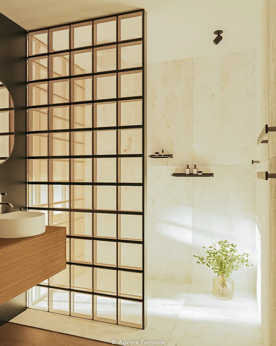 Salle de bain moderne avec douche à paroi en verre à cadres métalliques et lavabo sur meuble en bois.