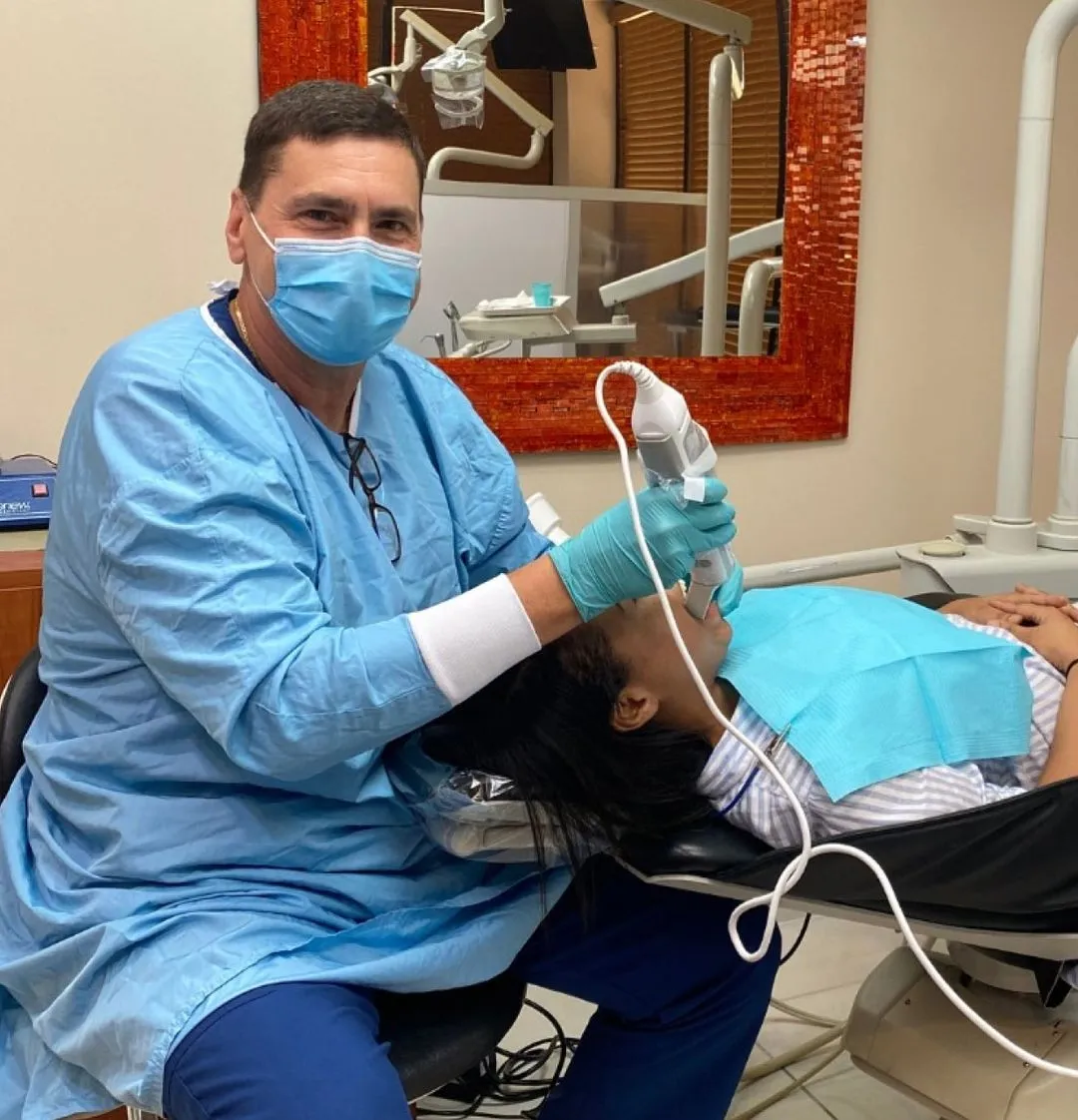 A man getting his teeth checked by a dentist.