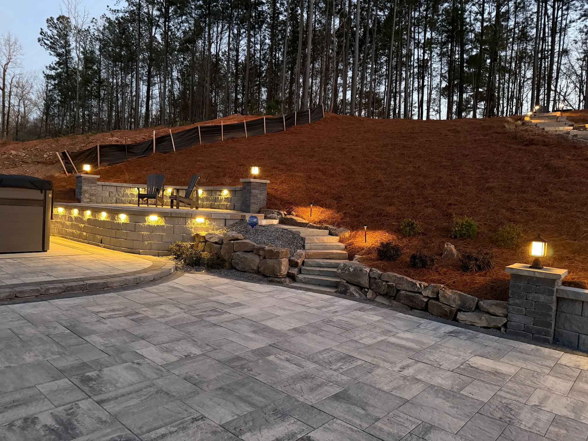 landscape at dusk with landscape lighting iluminating rock steps