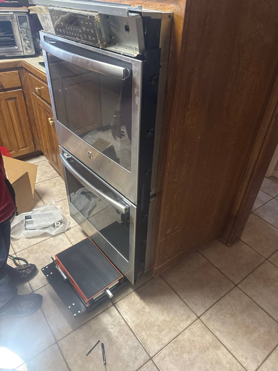 image of plumber working under a sink